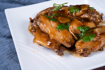 Cola chicken wings on a white plate
