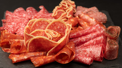 Different kinds of meat cuts on a board.