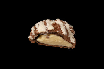 Profiteroles with coconut cream on a black background.