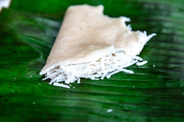 Traditional Brazilian tapioca with coconut served on a banana leaf. Amazonian tapioca