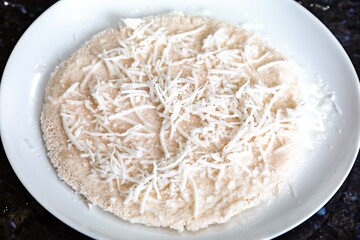 Traditional Brazilian tapioca with coconut served on a banana leaf. Amazonian tapioca