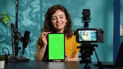 Woman filming tech tutorial on how to repair damaged mockup tablet using professional camera....