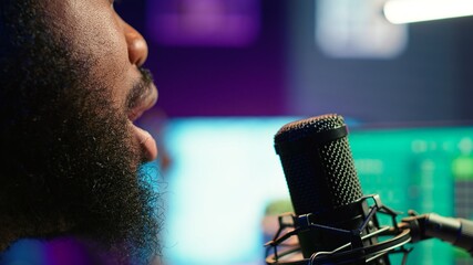 Skilled composer producing a new melody with lyrics and piano keys, recording audio files to edit...