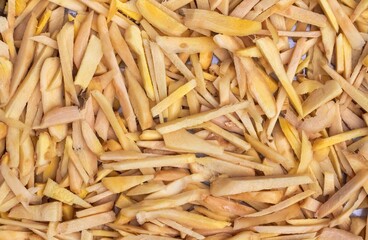 Raw Ginger Slices Heap Background with Copy Space in Horizontal Orientation