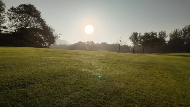  Panoramic view of the golf course with green grass and sun light morning time