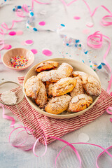 Traditional sweet crisp pastry with cream cheese, deep-fried, with powdered sugar. Carnival food with confetti