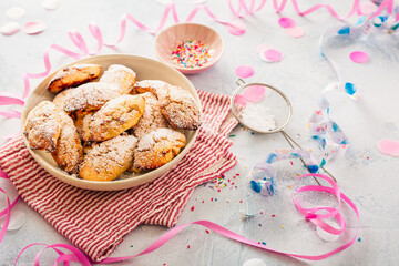Traditional sweet crisp pastry with cream cheese, deep-fried, with powdered sugar. Carnival food with confetti