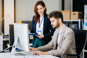 Obraz premium Diverse professionals collaborate on project analysis with financial graphs. Strategic teamwork and insights drive company growth and success.