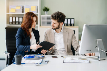 Diverse professionals collaborate on project analysis with financial graphs. Strategic teamwork and insights drive company growth and success.