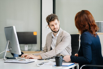 Diverse professionals collaborate on project analysis with financial graphs. Strategic teamwork and insights drive company growth and success.