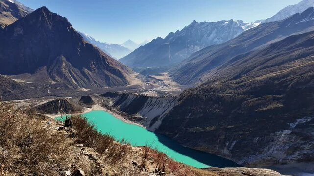 Manaslu, Nepal: Dramatic view of the Birendra Lake overlooking the Manaslu circuit trek near Sama on the way up to the base camp in the Himalayas in Nepal. Shot with a tilt up motion