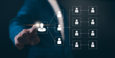 Businessman point a glowing digital organizational chart, leadership and team structure. Manager...