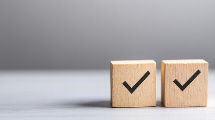 Two wooden blocks with black checkmarks on light background