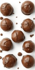 Fototapeta premium Six decadent chocolate truffles, glossy and perfectly formed, set against a pristine white background, appetizing, homemade