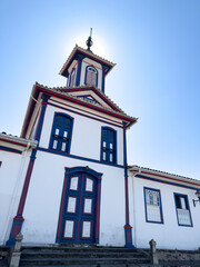 Sun Halo Over a Traditional Blue and White Church Facade