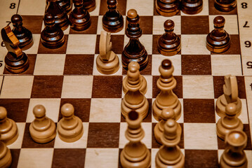 Chessboard with chess pieces top view, board game for two