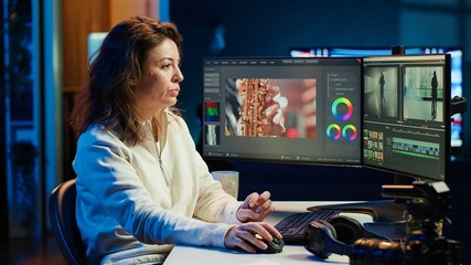 Portrait of happy video editor merging raw clips and footage into high quality finished videos in...