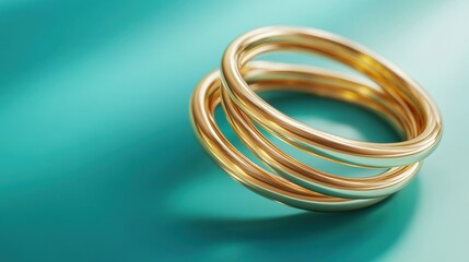 A stack of thin gold rings arranged on a turquoise background with shadows