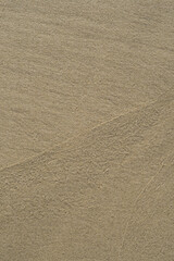 Empty background with wet sand on the beach.