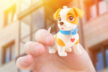 A hand holding a very small toy dog. Background on the theme of caring for pets.