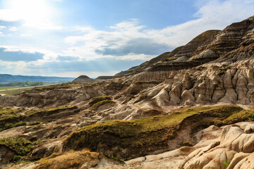 A rocky, barren landscape with a few patches of grass