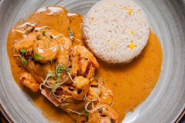 Grilled chicken with creamy sauce and rice.