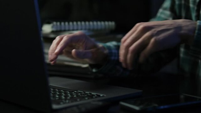 Close up a man working on computer, using touchpad, typing corporate message, communicating with clients. Student doing homework university assignment on laptop.
