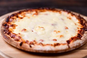 Pizza margherita on wooden background. Soft focus. Close up