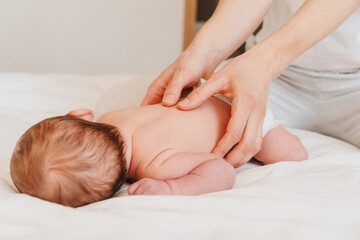 Mother and newborn baby. Baby care and massage.