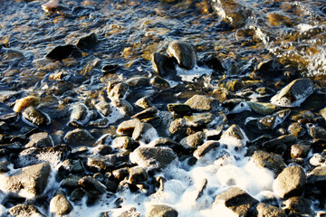 Water crashing over rocks at low tide