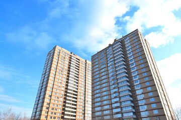 Fototapeta premium two tall buildings against a bright blue sky