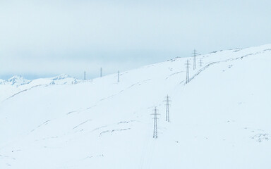 Power line in winter mountain.High voltage line over the mountain. Norwegian winter mountain.