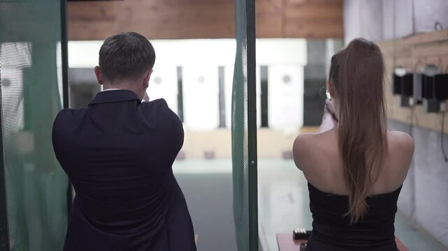 Shooting at the range by beautiful couple at 4k slow motion







