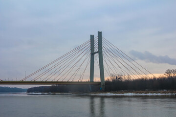 Obraz premium City bridge at dusk with cables stretching across the river