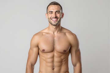 Fototapeta premium Smiling muscular man posing shirtless, displaying a fit and toned physique on a light background. Concept of fitness, health, and confidence. Ai generative