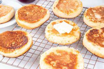 Traditional English skillet fried breakfast pastry Crumpets, popular in England, Britain pancakes. Sweet hot crumpets stack with melting butter and jam