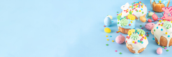 Bright colorful Easter cakes, pastries and eggs greeting card background with copy space,  Easter cooking concept, sweet treats sale, Easter party, spring baking fair invitation © ricka_kinamoto