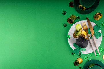 St. Patrick's Day festive table setting. Plate and cutlery, with golden coins, leprechaun pot,...