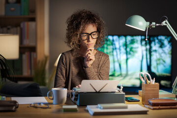 Creative writer working in her home office with a typewriter