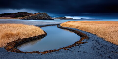 Serene Coastal Landscape with Flowing Stream and Dramatic Cloudy Sky Over Tidal Flats