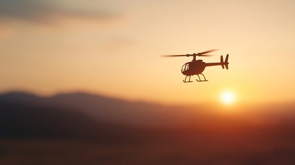 Fototapeta premium Remote-Controlled Toy Helicopter Silhouetted in Sunset Glow Over Mountainous Landscape