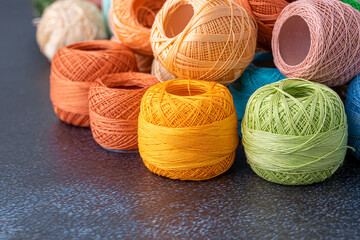 Multicolor yarn for knitting, knitting needles and scissors. Home storage concept and hobby.Raffia is an organic, ecological, wood fiber that is easy to crochet.