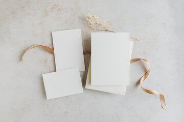 Wedding invitation cards samples with ribbon and dried wildflowers