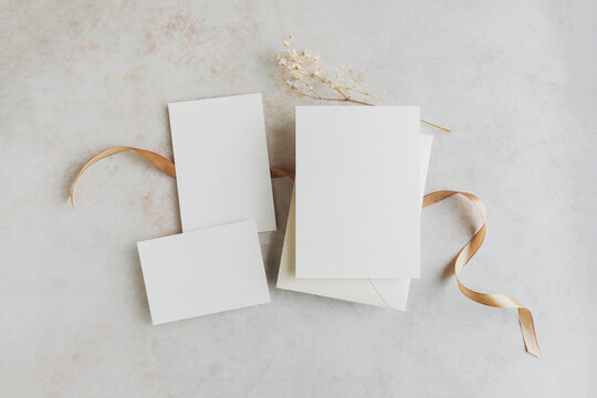 Wedding invitation cards samples with ribbon and dried wildflowers