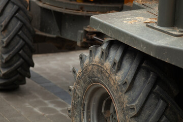 Close-up of muddy tires on heavy machinery.  Industrial equipment detail shot.