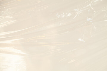 Abstract texture of translucent plastic wrap.  Smooth, flowing lines and subtle light reflections...