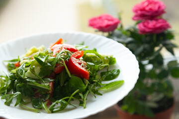 Fresh green salad with tomatoes, ready to be enjoyed.  Healthy and delicious!