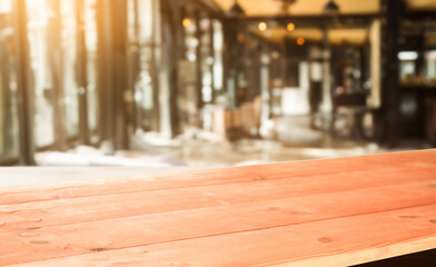 Empty wooden table against a blurred background of a modern cafe interior. Perfect for product placement or montage.
