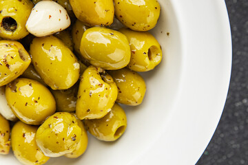 Mediterranean olives with garlic snack aperitif fresh tasty food dish delicious gourmet food background on the table rustic food top view copy space keto and paleo diet Vegetarian and vegan food