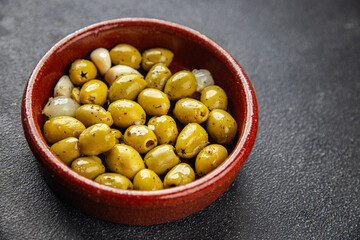 Mediterranean olives with garlic snack aperitif fresh tasty food dish delicious gourmet food background on the table rustic food top view copy space keto and paleo diet Vegetarian and vegan food